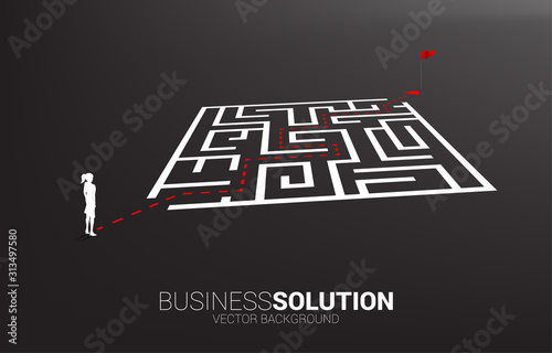 Silhouette of businesswoman with route path to exit the maze to light bulb. Business concept for problem solving and finding idea.