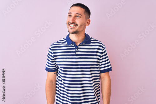 Wallpaper Mural Young handsome man wearing nautical striped t-shirt over pink isolated background looking away to side with smile on face, natural expression. Laughing confident. Torontodigital.ca