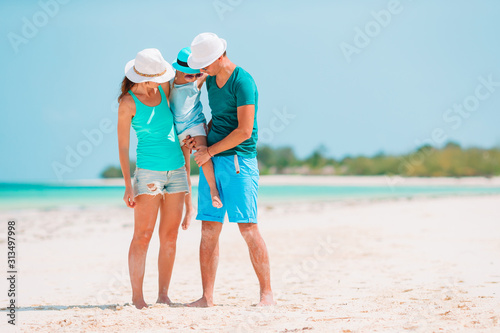 Young family on white beach during summer vacation