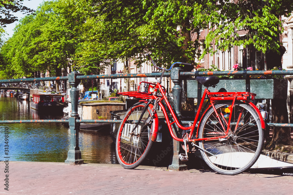 Traditional Dutch bike parked on a canal bridge in Amsterdam, Netherlands