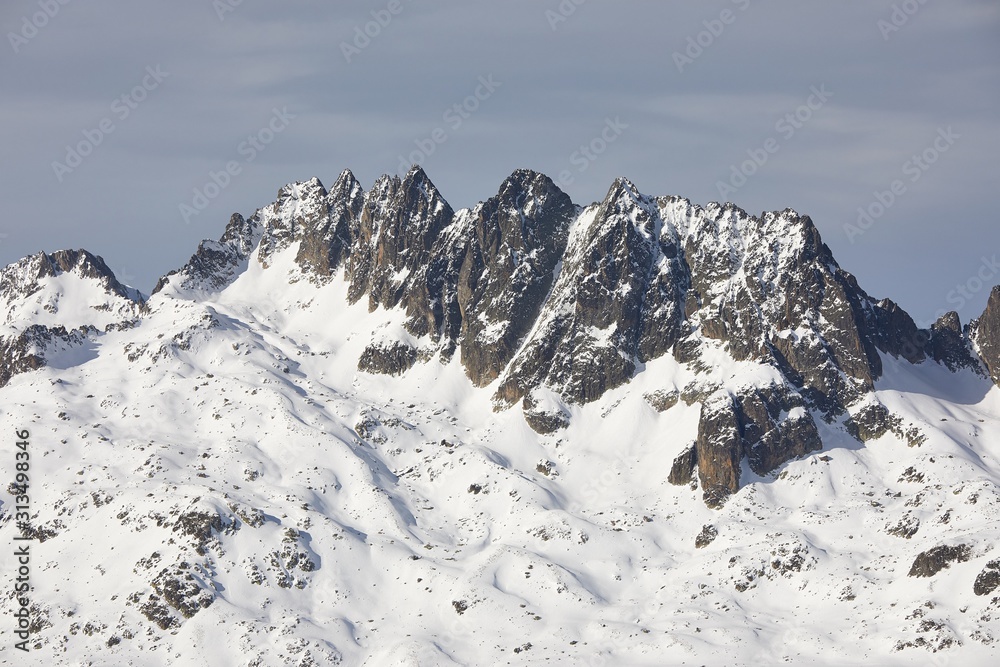 High mountain range in winter, rocky peaks