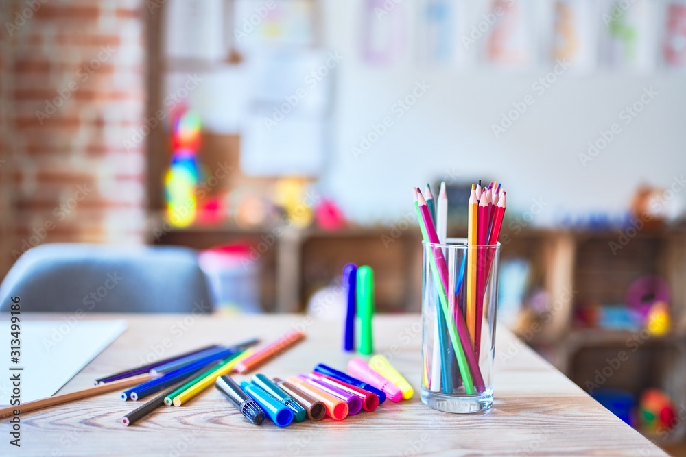 Desk with lots of colored pencils and pen to draw at kindergarten Desk with lots of colored pencils and pen to draw at kindergarten