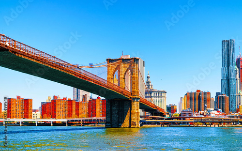 Brooklyn bridge across East River, New York, USA. It is among the oldest in the United States of America. NYC, US. Skyline and cityscape. American construction © Roman Babakin