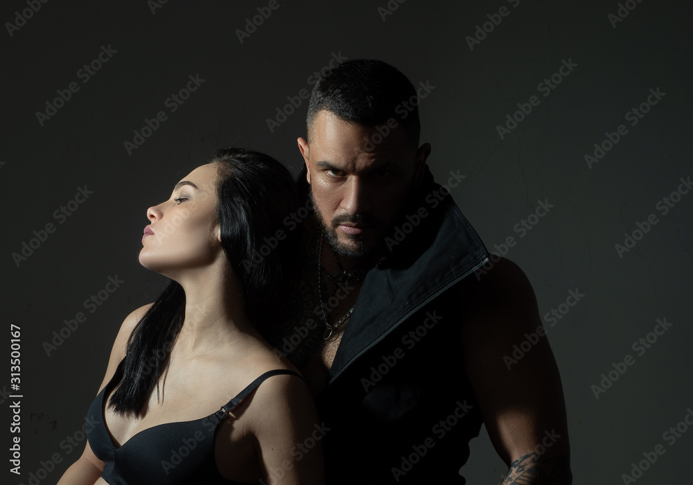 Muscular man. Couple in love on dark background. Relax. Fashion studio photo of beautiful couple. Couple In Love. Young sexy couple. Loving everything about her. Love. Beautiful young lovers. Muscular man. Couple in love on dark background. Relax. Fashion studio photo of beautiful couple. Couple In Love. Young sexy couple. Loving everything about her. Love. Beautiful young lovers.