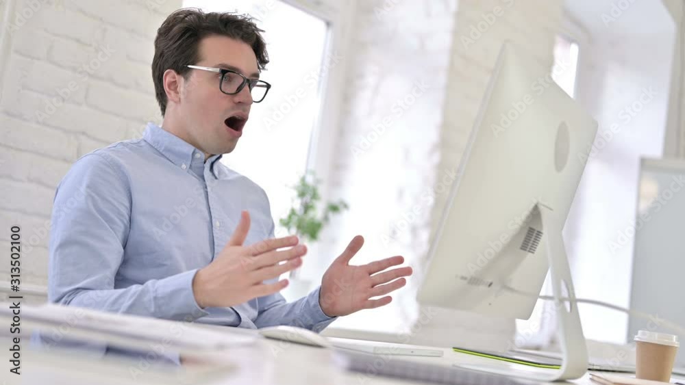 Surprised Working Young Man feeling Shocked in Office Surprised Working Young Man feeling Shocked in Office
