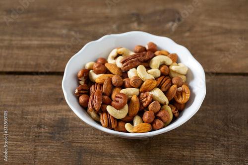 mixed nuts on wooden surface