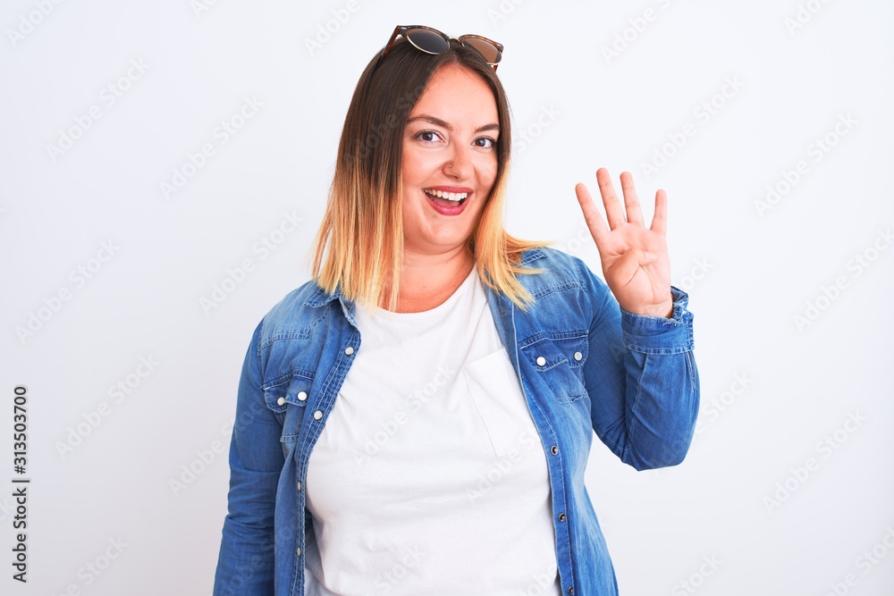 Beautiful woman wearing denim shirt standing over isolated white background showing and pointing up with fingers number four while smiling confident and happy. Beautiful woman wearing denim shirt standing over isolated white background showing and pointing up with fingers number four while smiling confident and happy.
