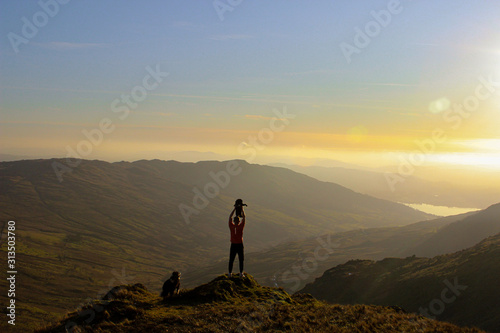 silhouette of man on top of mountain (lion king)