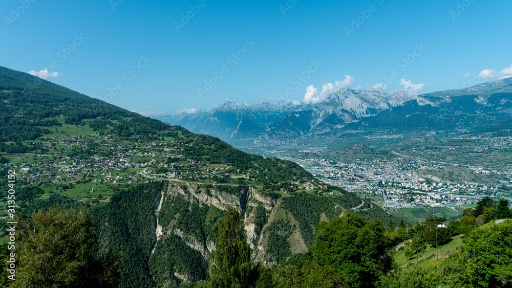 Village of Vex, perched at the top of the cliff, and overlooking the Sion valley. Canton of Valais,