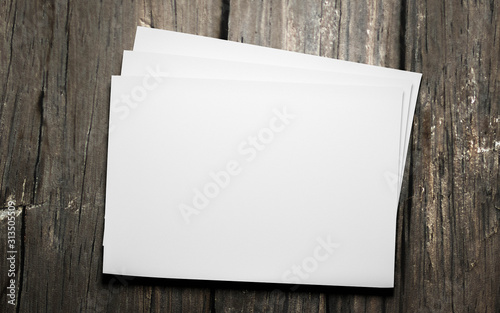 empty blank horicontal sheets isolated on dark wood background to replace your design 3d illustration render photo