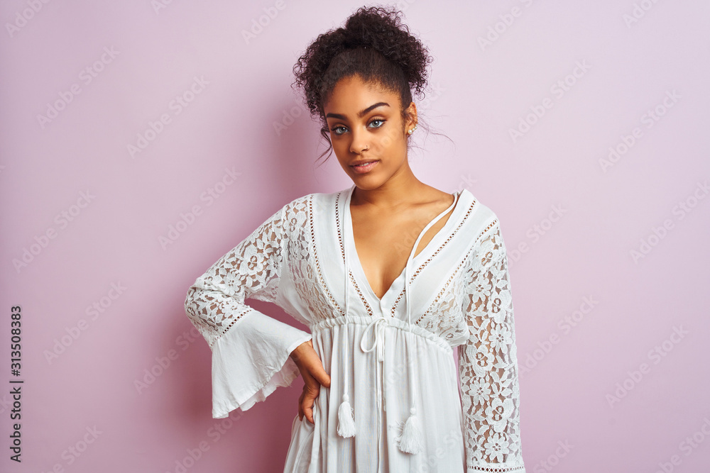 Young beautiful african american woman standing wearing elegant white dress Young beautiful african american woman standing wearing elegant white dress