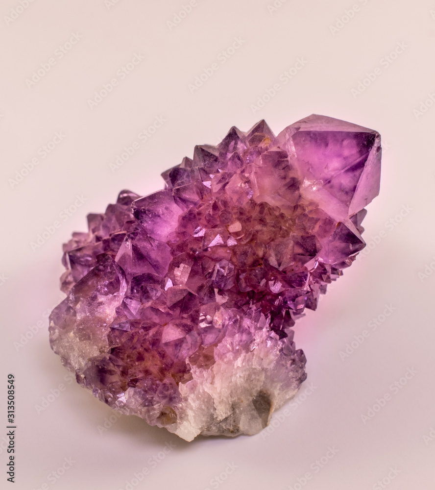 Amethyst stone isolated. Different amethyst crystal formation with one big point. Amethyst is one of the most using healing crystals with its positive energy. Absorbs negative energy in home or aura .