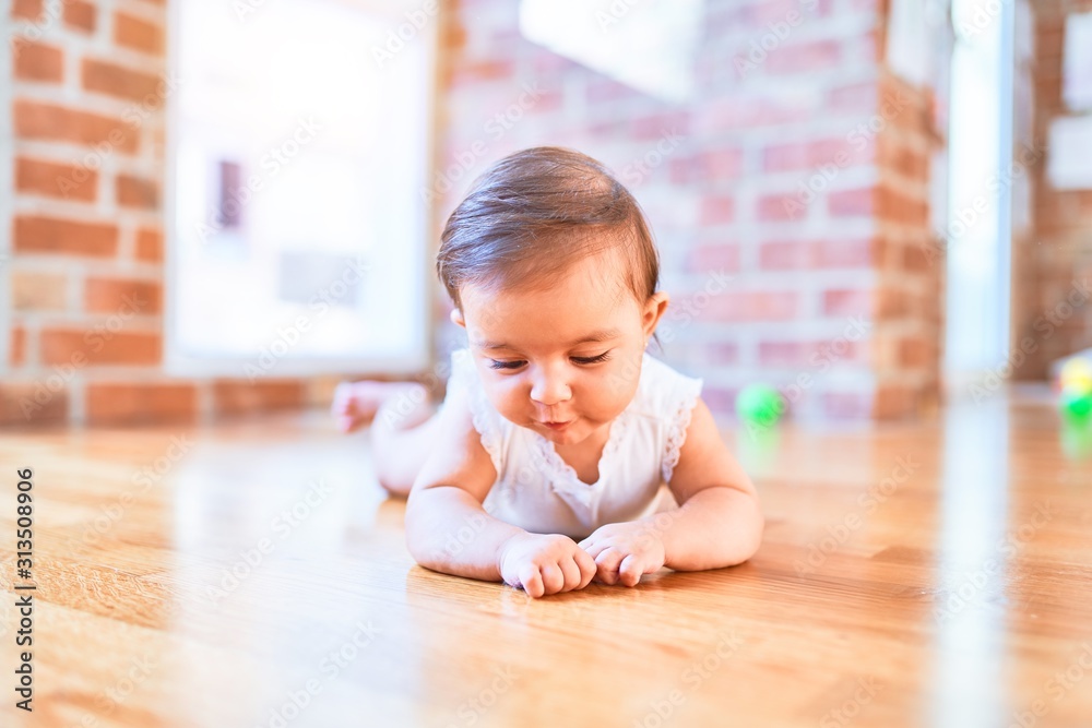 Beautiful infant happy at kindergarten around colorful toys Beautiful infant happy at kindergarten around colorful toys