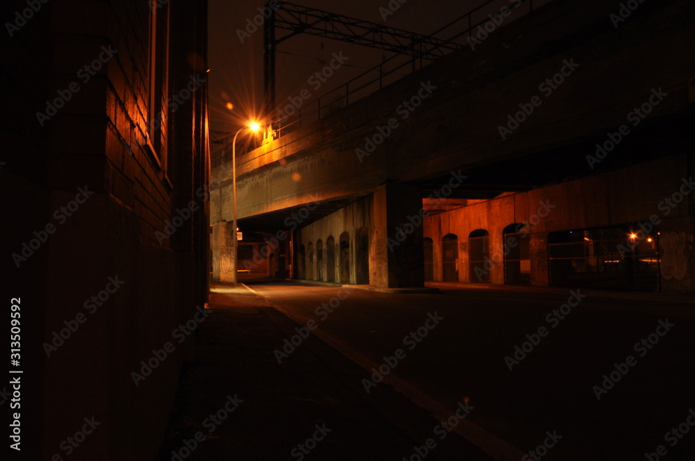 View of road and train overpass at night