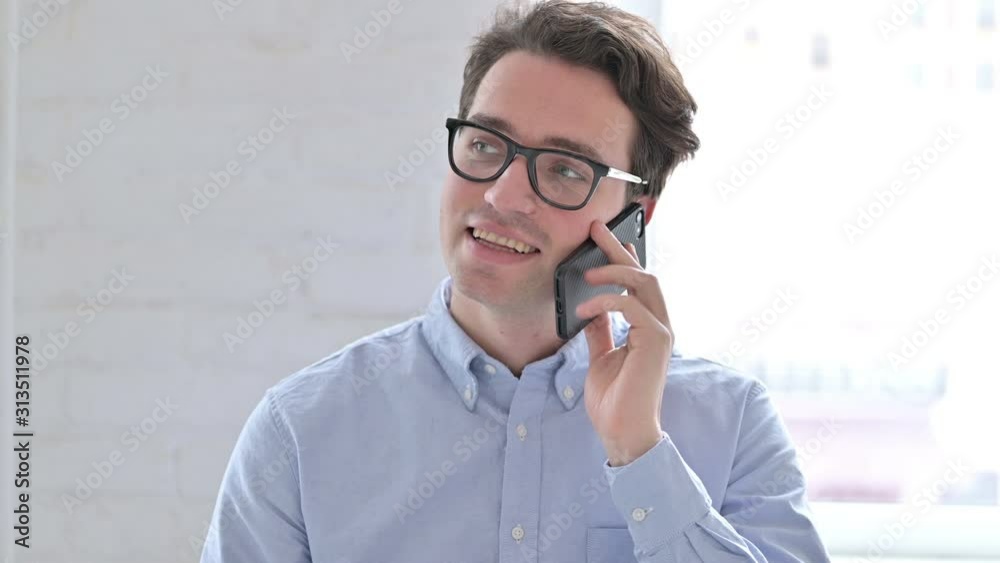 Portrait of Cheerful Young Man Talking on Smartphone 