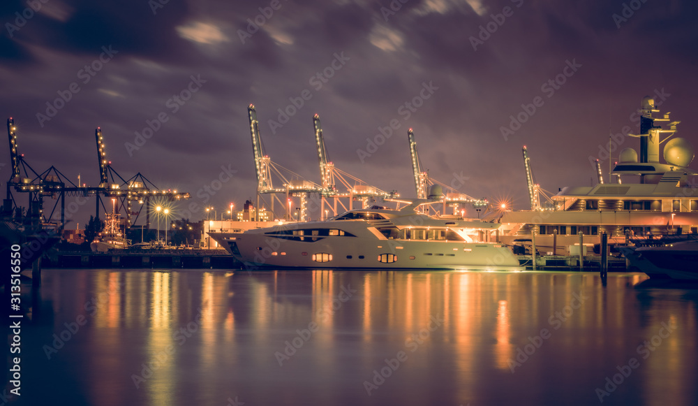 miami harbor sea night cargo boats water sky clouds cranes industrial alubrado