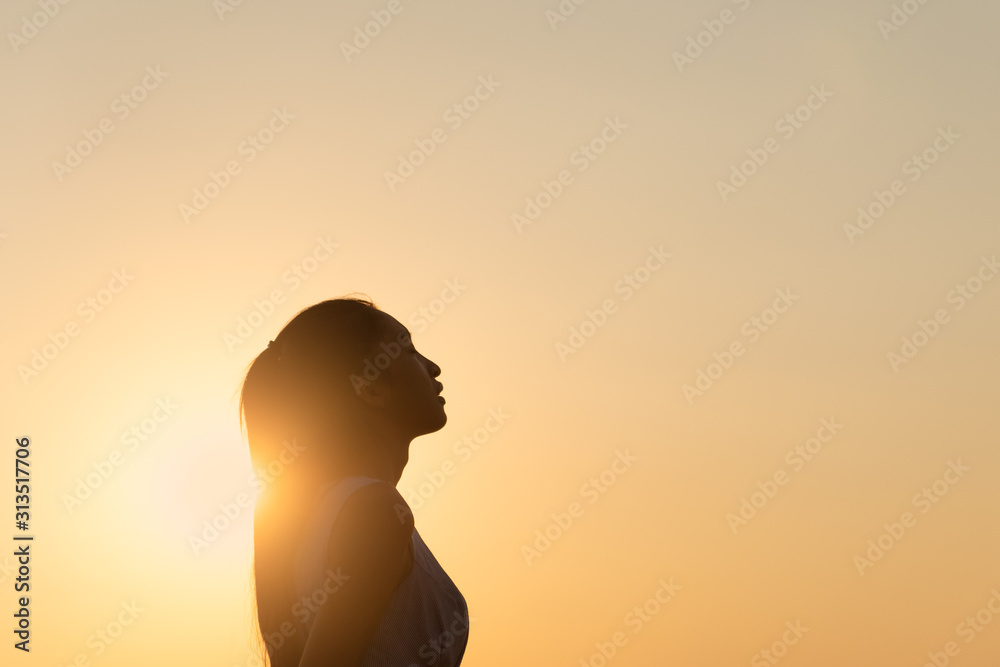 Free young woman at golden sunset. Freedom and success concept,relaxing and enjoying nature with copy space. Free young woman at golden sunset. Freedom and success concept,relaxing and enjoying nature with copy space.