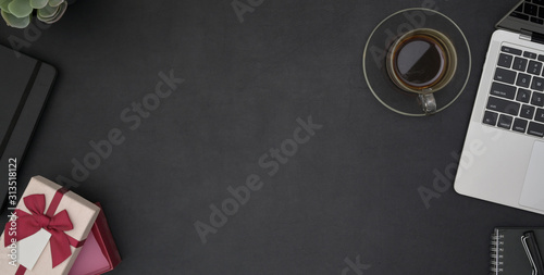 Top view of dark modern workplace with office supplies and copy space in black table
