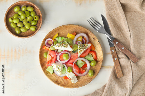 Composition with tasty Greek salad on table