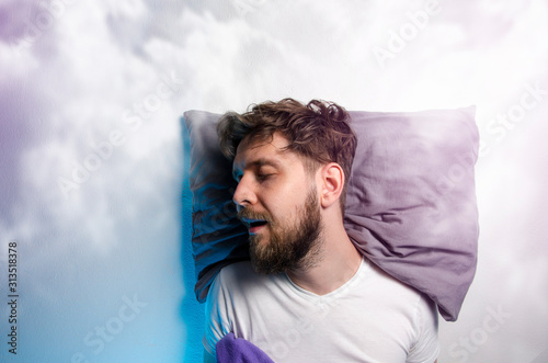 Man sound asleep , enjoying his nap, graphic clouds added , dreaming  photo