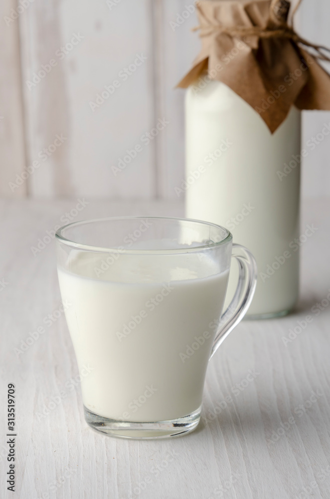 A glass bottle with kefir with bread rolls