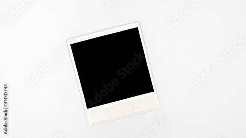 Retro empty photo frame. White plastic border isolated on white. Template photography, polaroid.