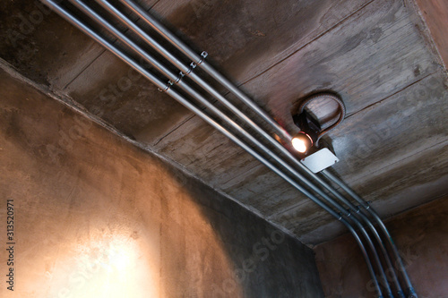 Electrical wiring work in a steel pipe of a house with a loft style decoration design. photo