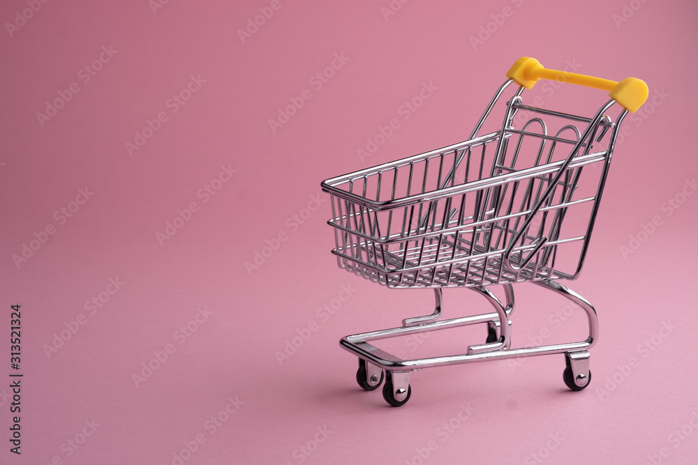 Turned pushcart empty on pink background, Black Friday concept. Turned pushcart empty on pink background, Black Friday concept.