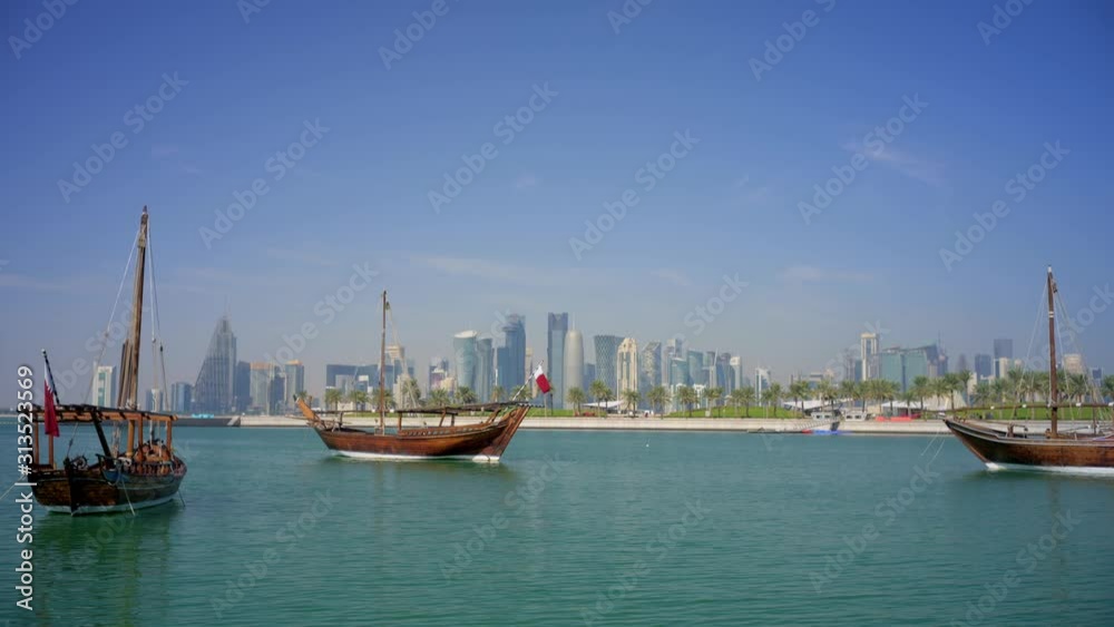 Three dhow boats with Doha West Bay in the background Three dhow boats with Doha West Bay in the background