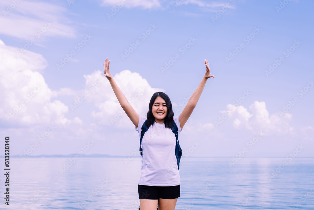 Happy woman standing with open hands at sea,Enjoying in Nature,Freedom concept Happy woman standing with open hands at sea,Enjoying in Nature,Freedom concept