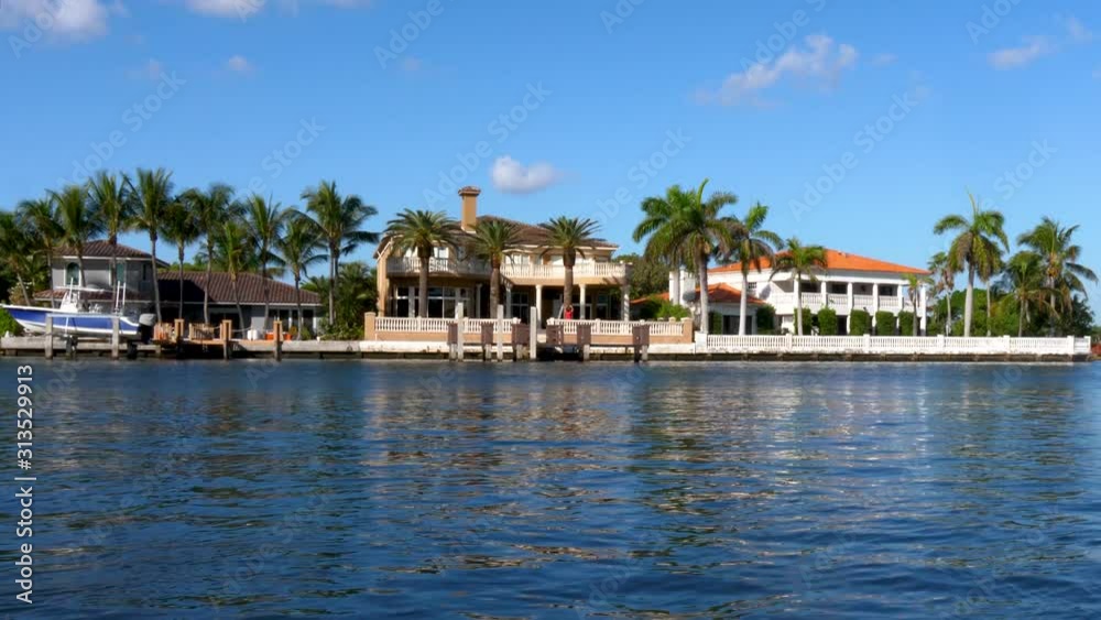 Miami lake house with reflection and palm trees, establishing shot Miami lake house with reflection and palm trees, establishing shot