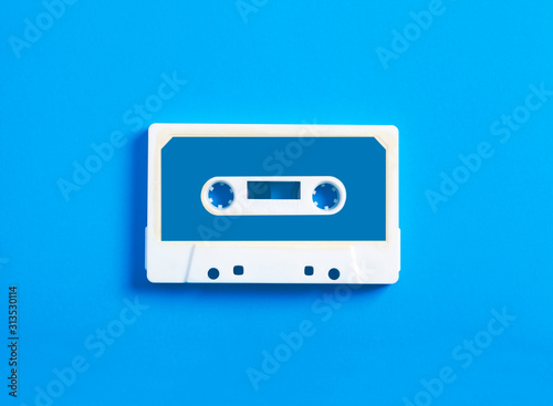 Retro cassette tape on blue background  top view.