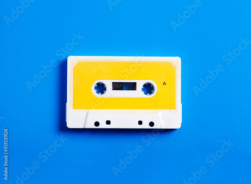 Tela Retro cassette tape on blue background, top view.