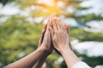 Team High five teamwork working together diverse hands up show power of tag team. Hands of multiethnic diversity people togetherness volunteer. Collaborate business team success concept