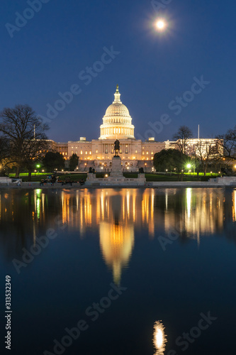 United States Capitol Building at twilight time with super full moon reflection with the big pool, Washington, DC, United States of America or USA, history and culture for travel concept