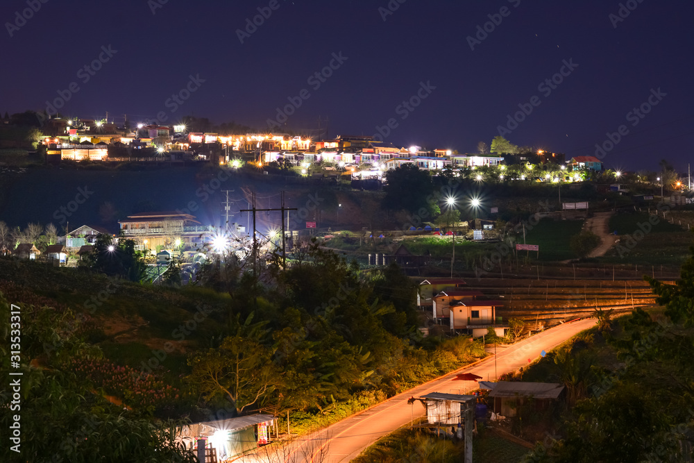 Fototapeta premium High view beautiful nature landscape of colorful sky during the sunrise, see the lights of the road and city from the campsite at Phu Thap Berk viewpoint, Phetchabun Province, Thailand