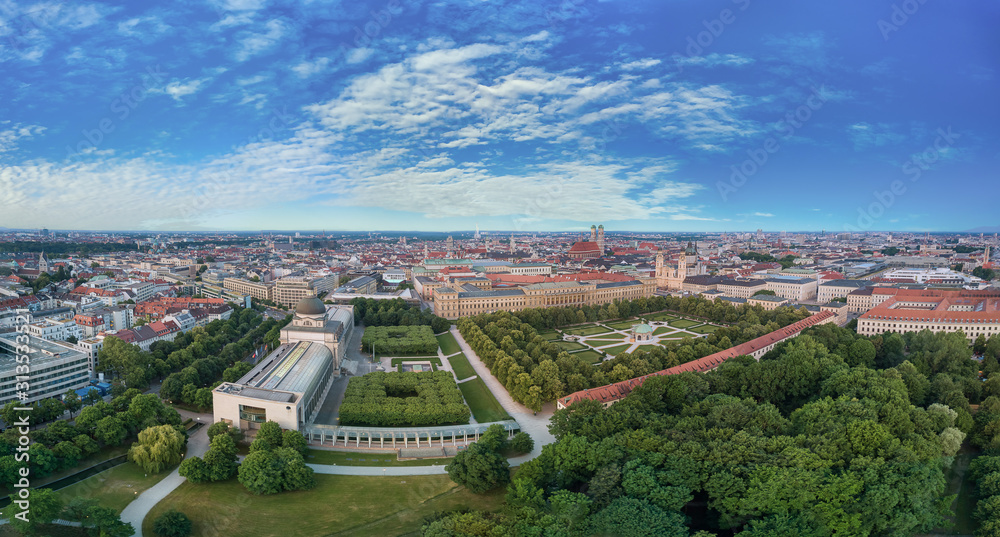 Drone view over the beautiful aera of Munich city as a wide panorama with blue sky.