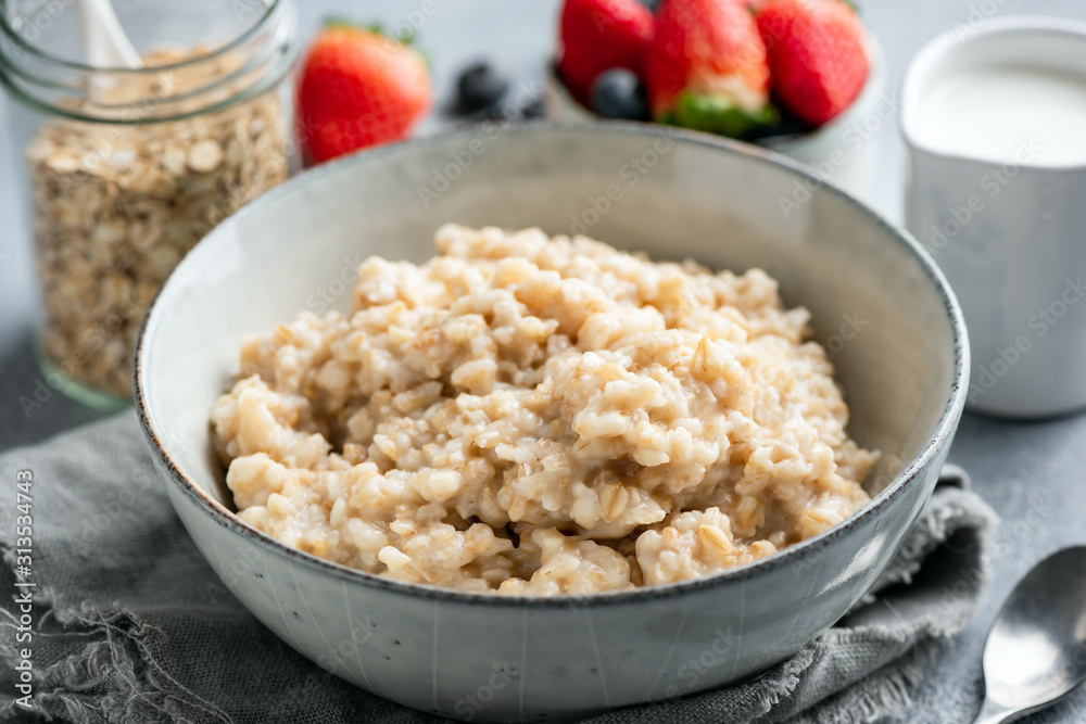 Oatmeal porridge, cooked steel cut oats in bowl. Healthy breakfast food Oatmeal porridge, cooked steel cut oats in bowl. Healthy breakfast food
