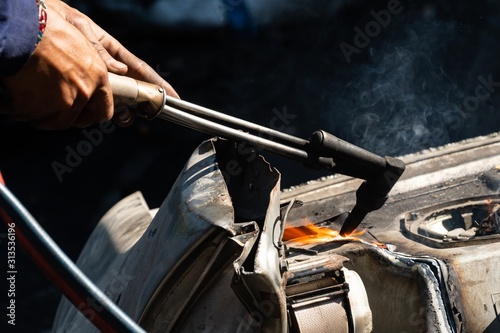 Oxy-Fuel Cutting Torch to cutting car for metal recycling photo