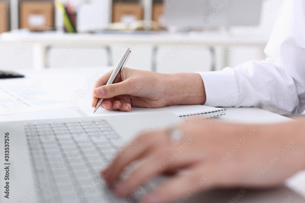 Fototapeta premium Business woman in the office holds hand on laptop