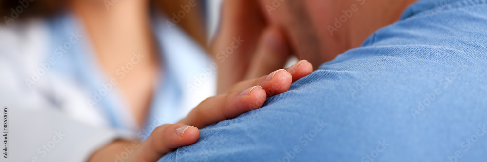 Friendly female doctor hold patient shoulder Friendly female doctor hold patient shoulder