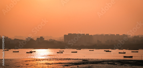 Vászonkép Panoramic silhouette of surat city while sun rising near ONGC bridge