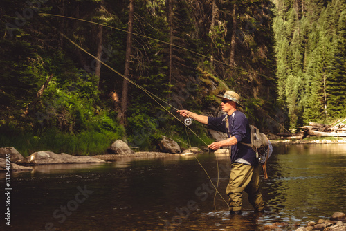A fly fisherman fishing for trout on the mountain river in Northern Idaho.