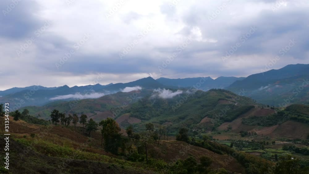 Time-lapse shot the scenic landscape of natural forest and mountain after rain with fog and cloud Time-lapse shot the scenic landscape of natural forest and mountain after rain with fog and cloud