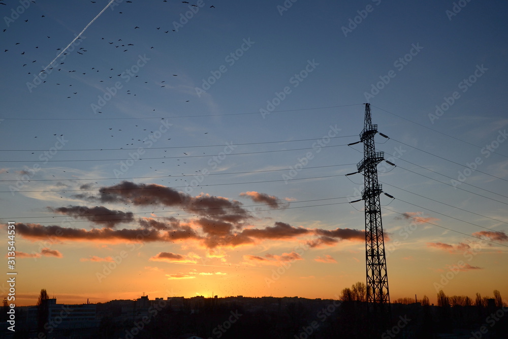 silhouette of electricity pylon at sunset