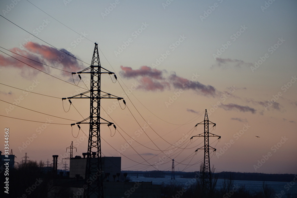 silhouette of electricity pylons at sunset