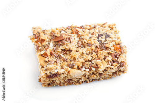 Homemade granola from oat flakes, dates, dried apricots, raisins, nuts isolated on white background. Side view.