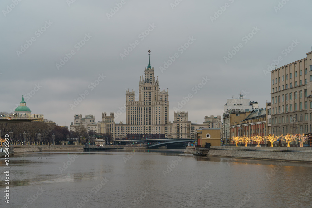 Photography of Stalinist skyscraper on Kotelnicheskaya embankment and Observation Deck Zaryadye Park in winter overcast day. International touristic concepts.