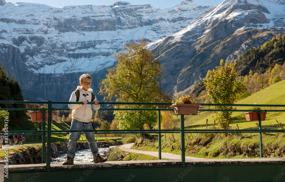 smiling boy with backpack in Cirque de Gavarnie; Pyrenees mountains