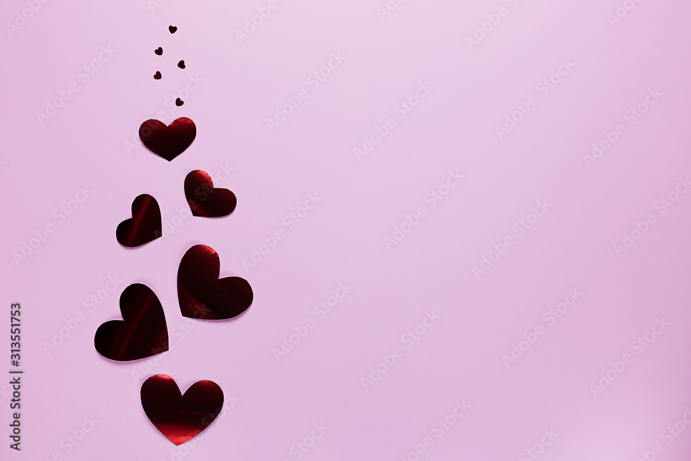 Flying red hearts on a pink background. Valentine's day. Holiday of lovers. Flying red hearts on a pink background. Valentine's day. Holiday of lovers.